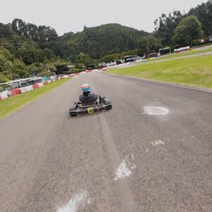 Video del piloto con casco blanco y líneas azul y naranja